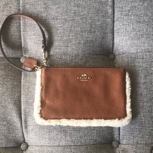 Coach fur/fleece lined leather medium wristlet